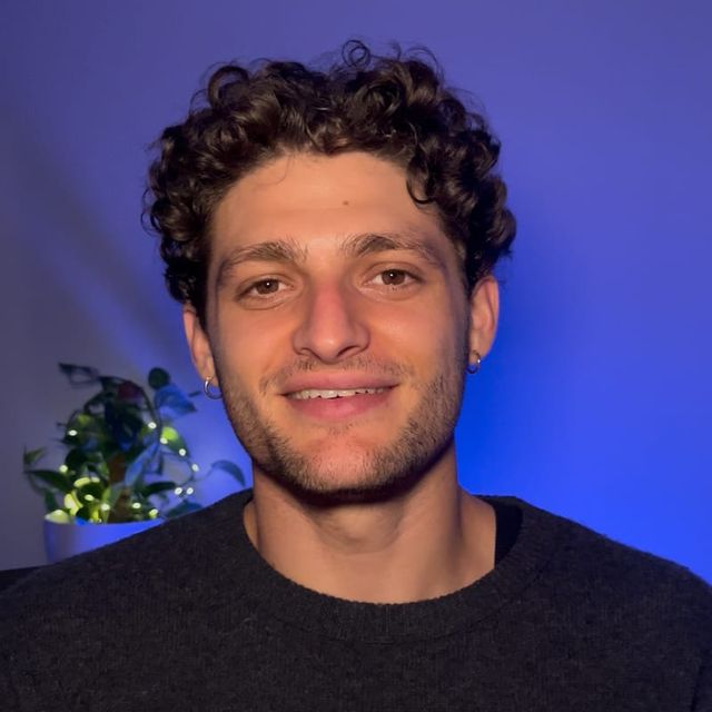 Nathaniel Giabardo, smiling, in a dark jumper